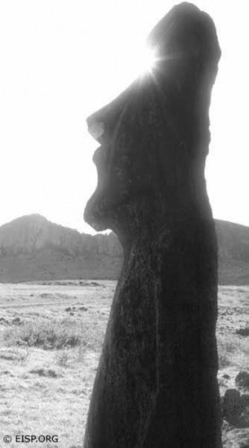 Empty eyesockets of a bearded moai standing near Ahu Tongariki are magically filled with sunbeams.  Photo by David C. Ochnser, copyright EISP, 1989.
